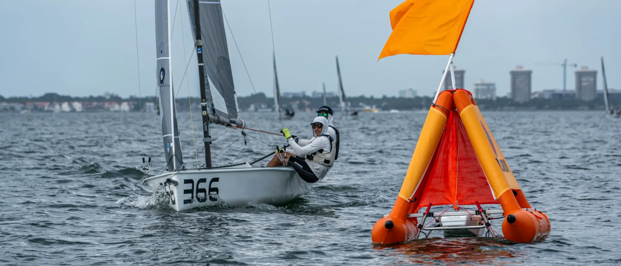A Vx One sails past a RoboMark holding its station at the Bacardi Cup, Miami