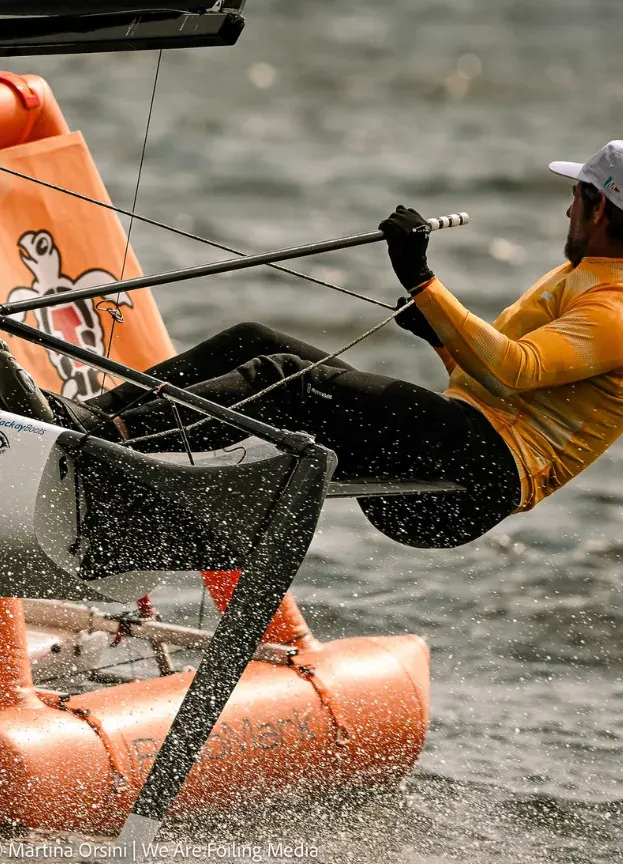 A sailor hikes hard as he rounds a RoboMark